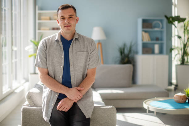 istock Man posing peacefully in elegant minimalist living room 2185828576