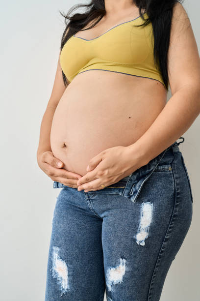 istock Pregnant woman holding her belly with both hands 2185828700