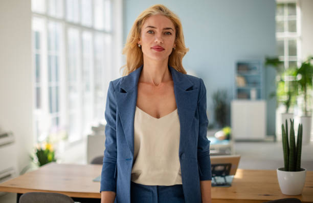 istock Stylish female professional in sunlit office area 2185830829