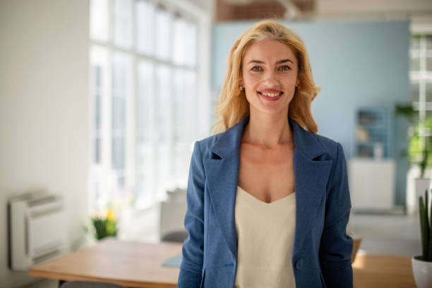 istock Successful businesswoman smiling in daylight office 2185830900
