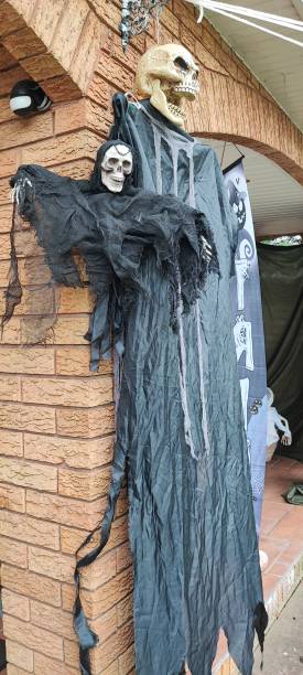 istock Two skeleton ghosts, one in grey robes and one is a bat skeleton. Halloween decorations. 2185833065