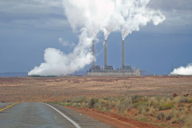 pollution from an industrial chimney blowing smoke up in the sky