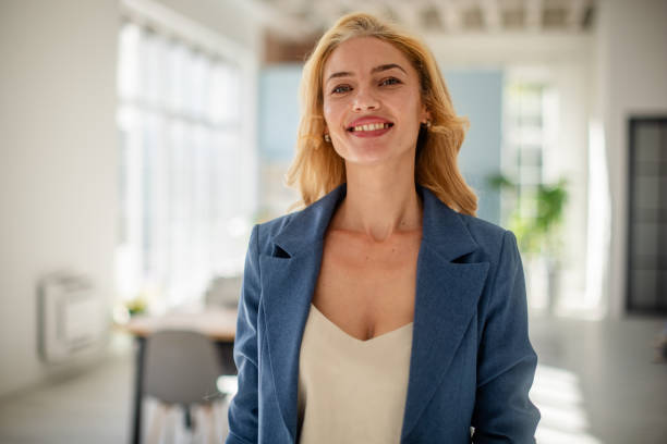 istock Woman smiling confidently in a sunny modern office 2185833190