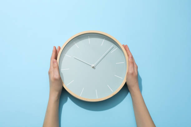 istock Concept of time change with clock on blue background 2185834093