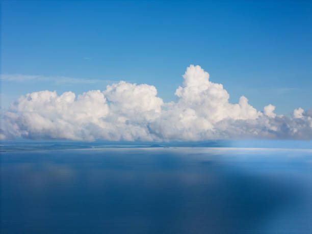 istock Beautiful clouds reflecting over calm blue ocean waters under bright clear sky 2185837166