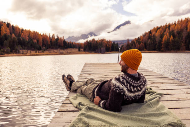 istock Relaxing on a Pier by an Autumn Lake 2185838703
