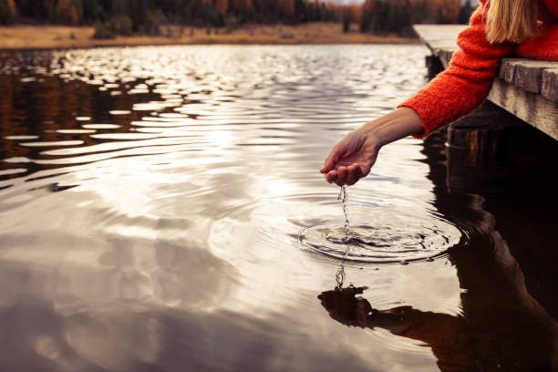 istock Hand Touching Rippling Lake Water 2185838886