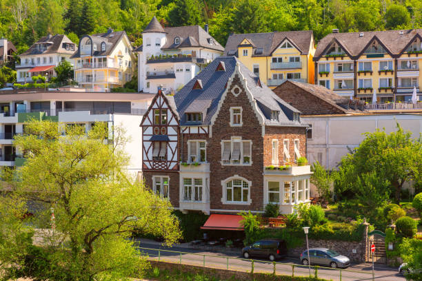 View of traditional half-timbered houses next to modern buildings in Cochem, Germany