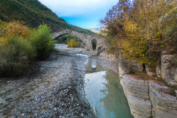 Aerial view of Ura e Kasabashit old stone bridge, Skrapar, Albania from drone