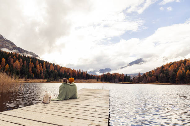 istock Cozy Couple Enjoying Autumn Lake View 2185844657