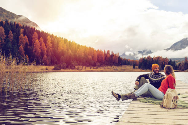 istock Couple Relaxing by a Serene Mountain Lake 2185844738