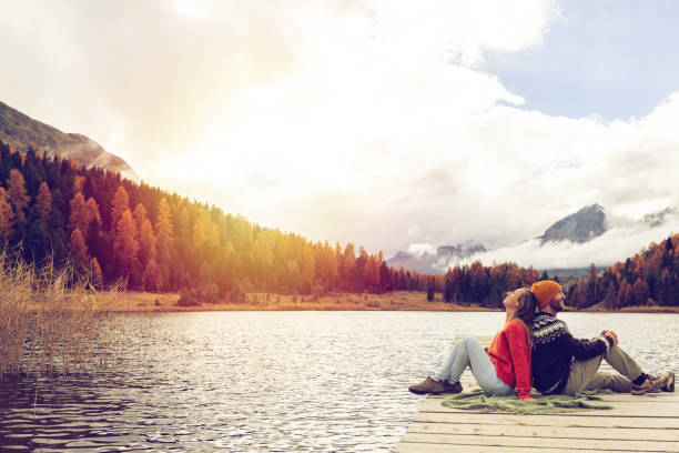 istock Couple Enjoying Serenity on a Lake Pier 2185844850