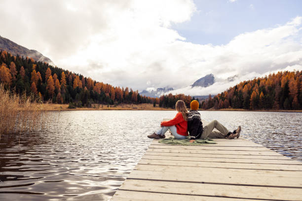 istock Couple Enjoying Serenity on a Lake Pier 2185844852