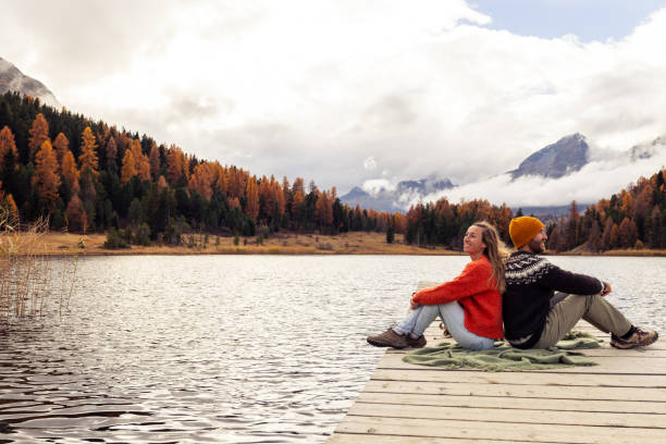 istock Couple Enjoying Serenity on a Lake Pier 2185844859