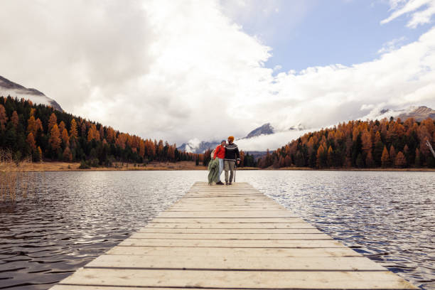 istock Couple Walking on Pier by Scenic Lake 2185845020