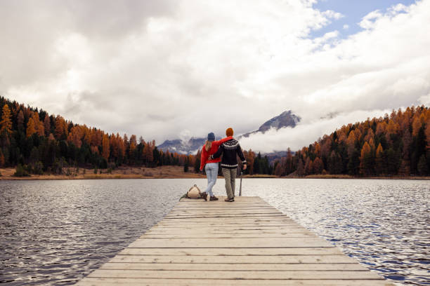 istock Couple Embracing on a Scenic Lakeside Pier 2185845076
