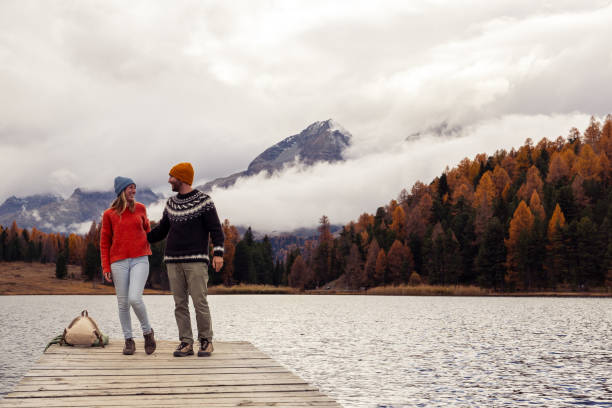 istock Couple Strolling on a Lakeside Pier in Autumn 2185845122