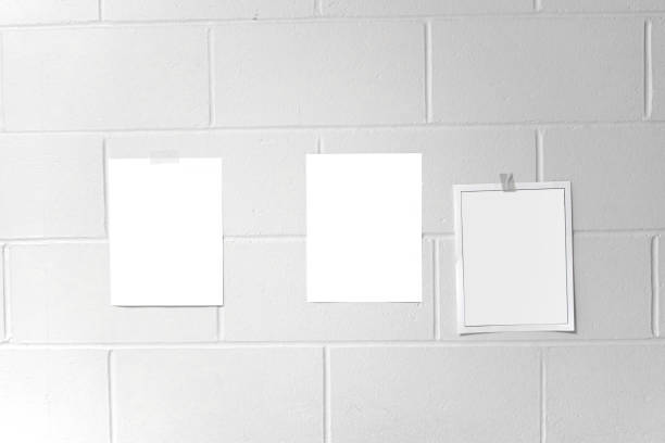 istock White paper stick on the white wall 2185847541
