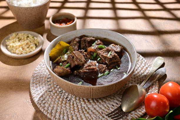 istock Rawon known as Indonesian Traditional Beff Black Soup from Java. Served on a Bowl with rice and chilli paste (sambal). 2185847720