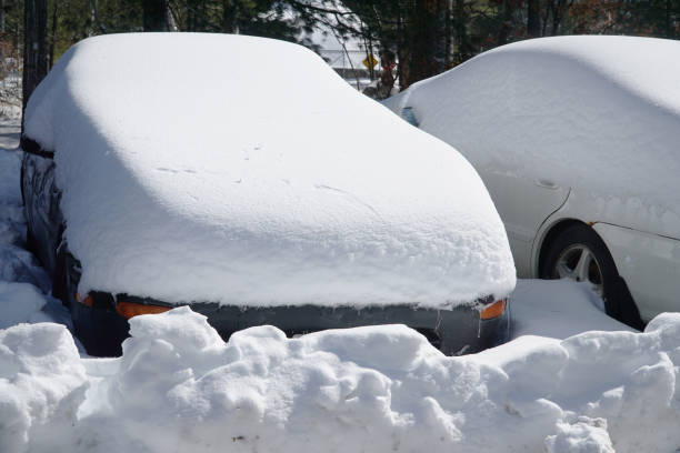 istock car covered with snow after blizzard in parking area 2185848671