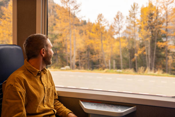 istock Passenger Enjoying Scenic Autumn Train Ride 2185848889