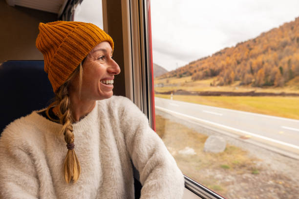 istock Smiling Woman Enjoying Scenic Train Ride 2185848897