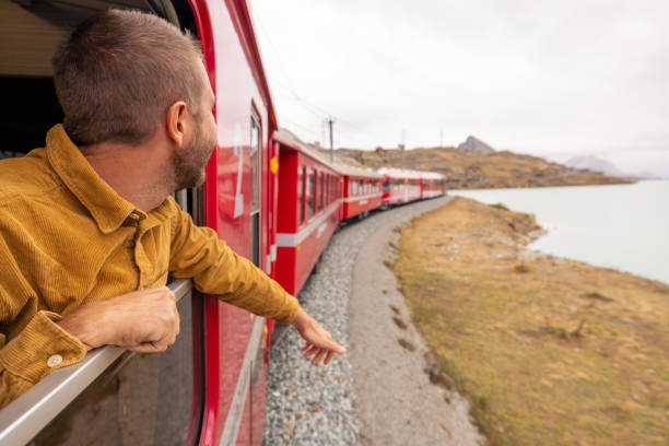 istock Male passenger train enjoys the panorama from an opened window 2185848962