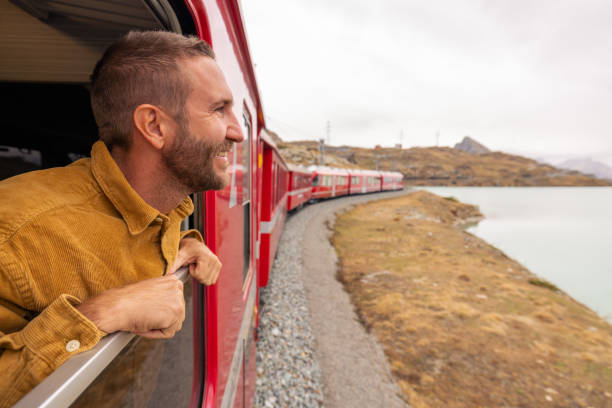 istock Man Enjoying Scenic Train Journey 2185848963