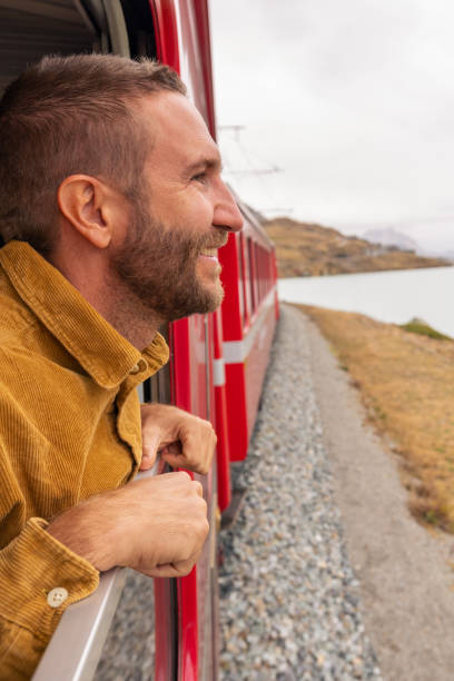 istock Man Enjoying Scenic Train Journey 2185848965
