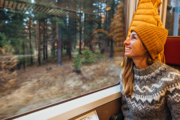 istock Woman Smiling by Train Window with Autumn Views 2185849020