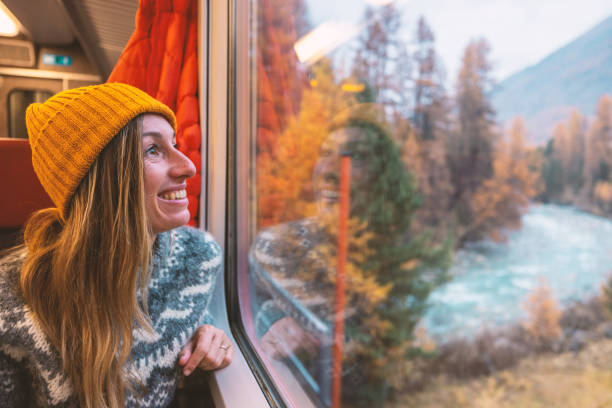 istock Woman Enjoying Autumn Scenery from Train Window 2185849028