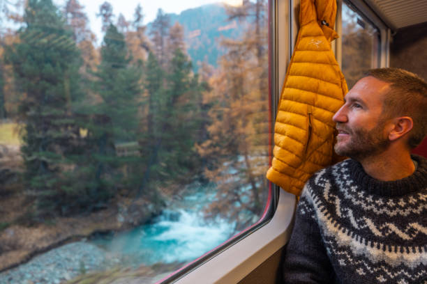 istock Man Admiring Autumn Views from Train Window 2185849036
