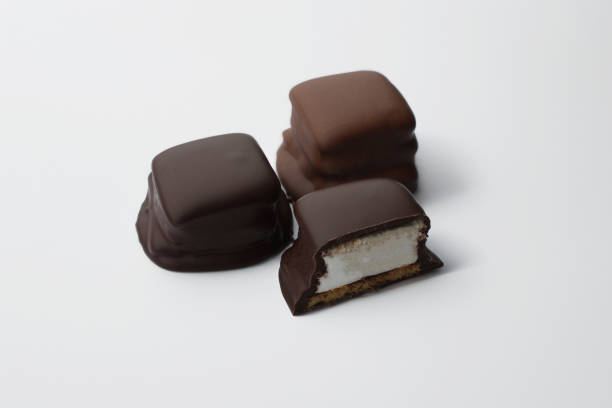 istock Three chocolate s'more stacked with hand made marshmallows and graham crackers ready to eat, on a white background 2185851874