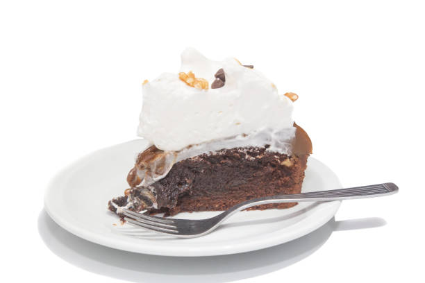 Slice of chocolate brownie cake, walnut, dulce de leche and meringue isolated on white. Argentine gastronomy