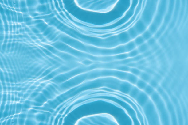 istock Blue water with ripples on the surface. Defocus blurred transparent blue colored clear calm water surface texture with splashes and bubbles. Water waves with shining pattern texture background. 2185854869