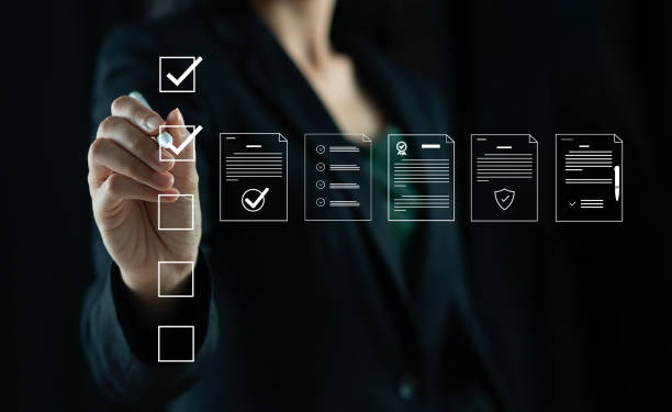 istock Businessman marking items in digital checklist. Quality assurance and document control with icons, representing quality assurance and document control processes, auditing and compliance. 2185857502