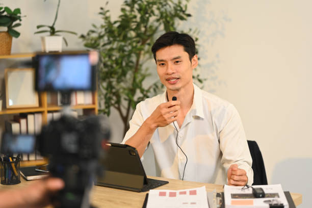 istock Experienced businessman speaking into a microphone during a video recording session 2185859295