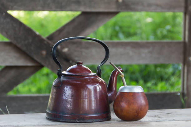 istock mate and kettle, traditional Argentine yerba mate infusion, on rustic wooden background 2185859332