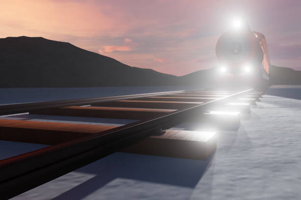 A train is traveling down a track with a mountain in the background. The train is lit up, creating a sense of movement and excitement. The scene is peaceful and serene