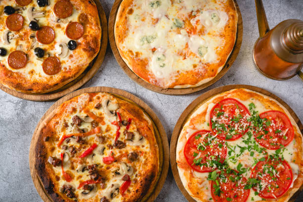 istock Top view of various neapolitan pizzas on grey stone table 2185862182
