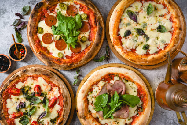 istock Top view of various neapolitan pizzas on grey stone table 2185862186