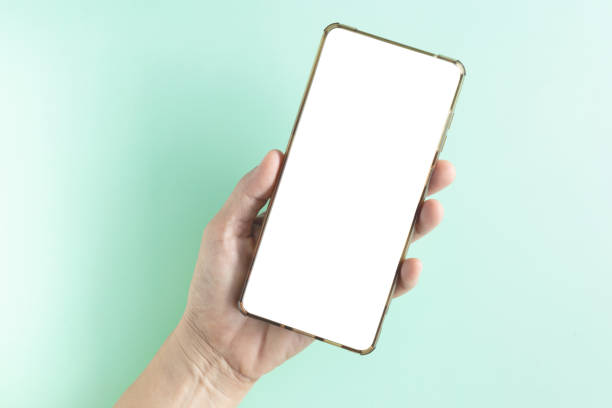 istock Hand-holding smartphone shows a white screen display on brown background. Top view, flat lay with copy space. 2185862266