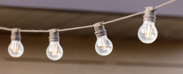 istock A string of lights with four bulbs hanging from a wire 2185863150