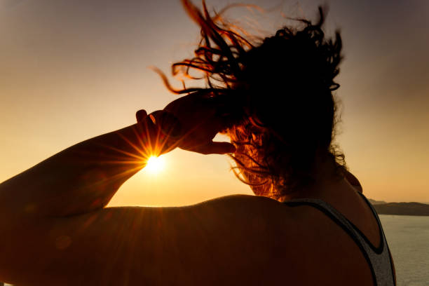 istock Female athlete doing sit-ups in summer day at sunset. 2185863636