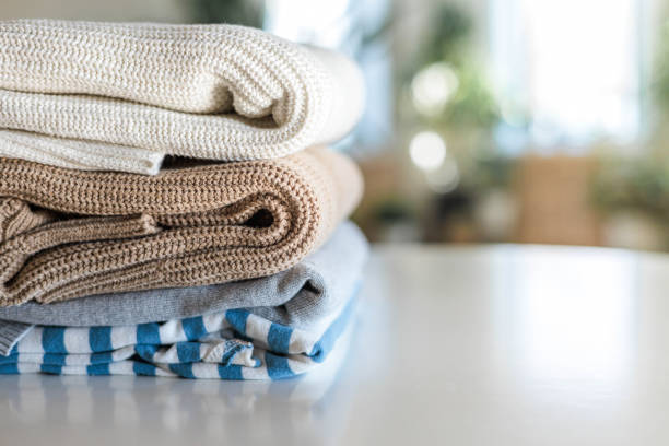 istock Neatly folded warm knitted sweater stack clothes storage top view isolated on white 2185868639