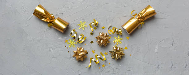 istock Christmas crackers with shiny confetti on color background, top view, copy space 2185868900
