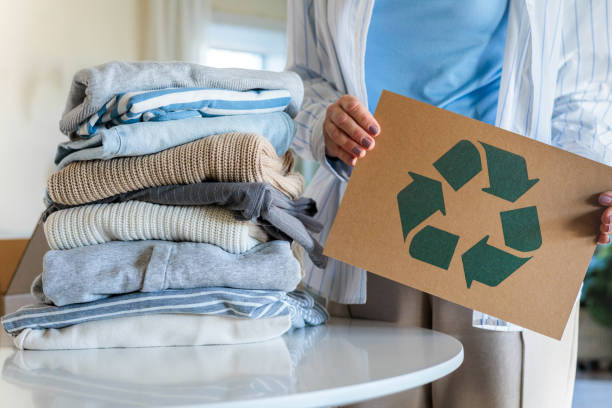 istock Female hands holding signboard textile clothes recycling reusing zero waste closeup 2185871240