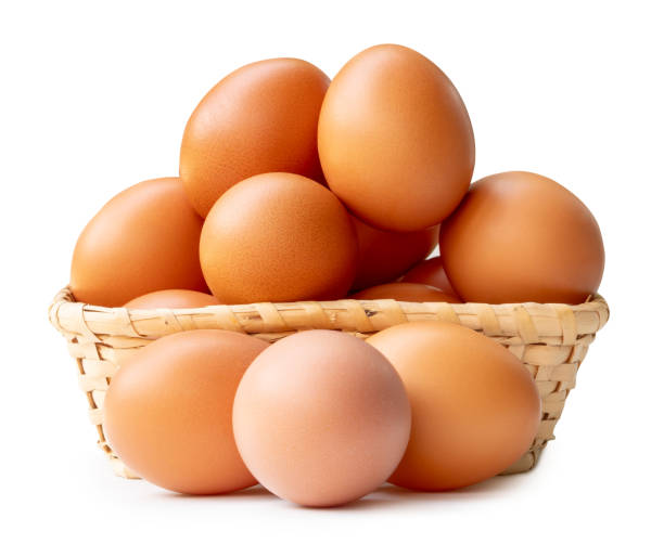 istock Group of fresh brown chicken eggs in stack in wicker basket isolated on white background with clipping path 2185872167