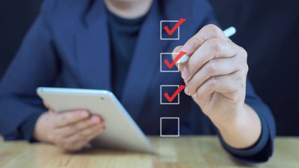 istock Businessman making correct sign mark on checkboxes to approve corporate project for business project approval concept.businessman using smartphone to do online survey, 2185876013