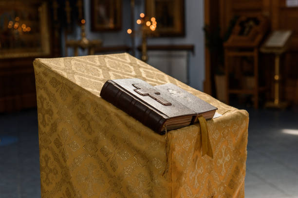 cross is placed on the Bible after prayer to God, which is religious ritual of Christianity and belief in the teachings of God. concept of praying to God with the teachings of the Bible and cross.
